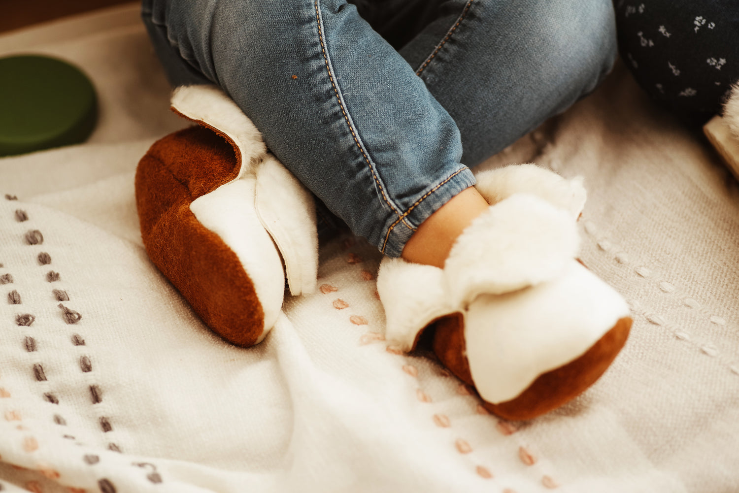 Baby and toddler merino sheepskin slippers with a suede leather cover