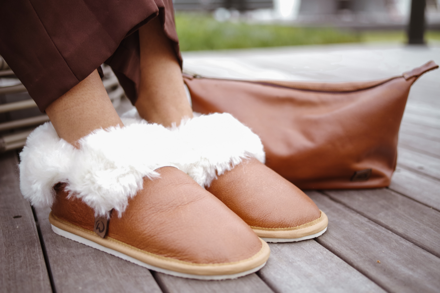 Tan Classic Merino Sheepskin slippers and a toiletry bag with a genuine leather cover and shweshwe lining